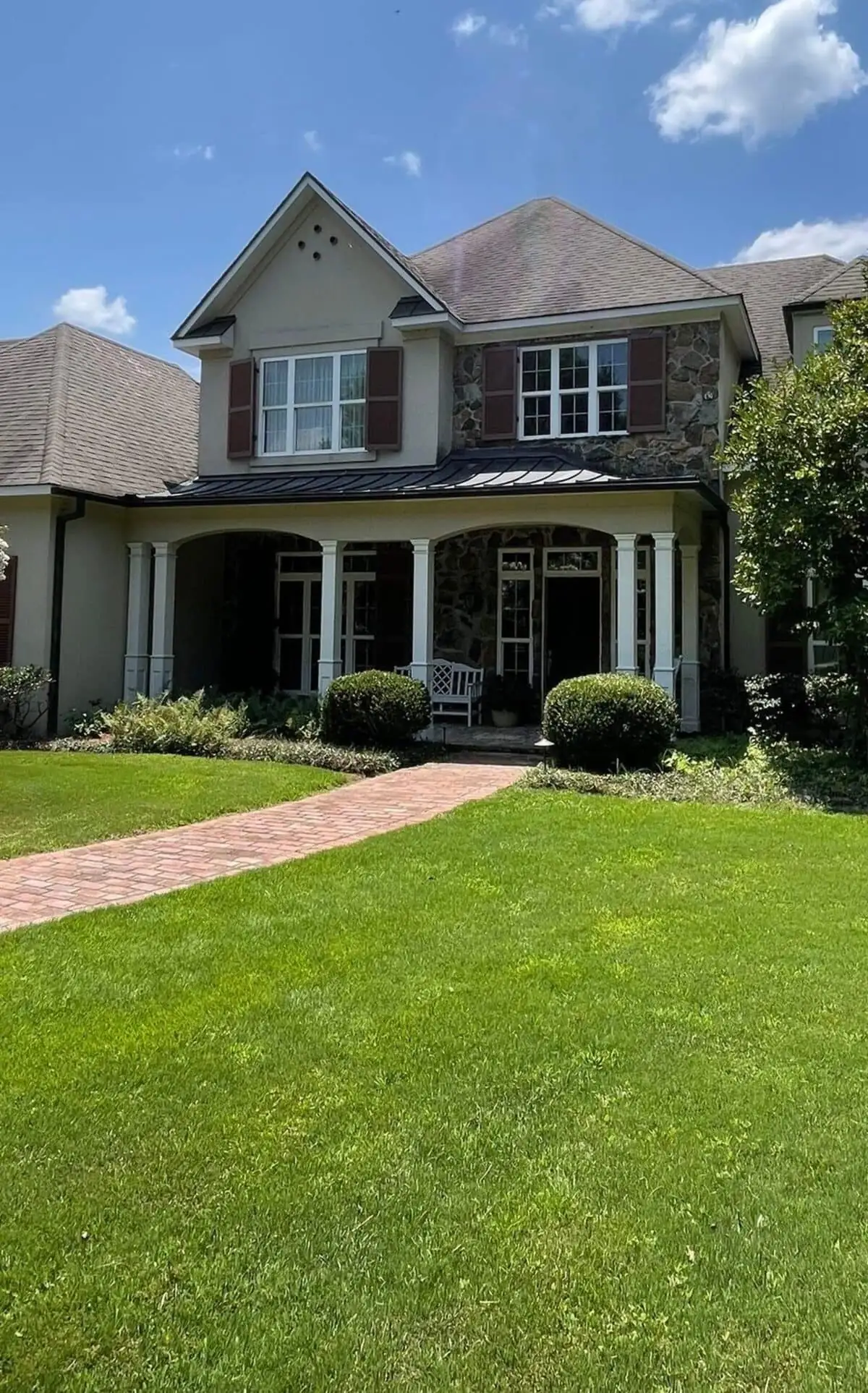 Two-storey home with a completed roof and finished landscaping, residential roofing serving Flowood, MS
