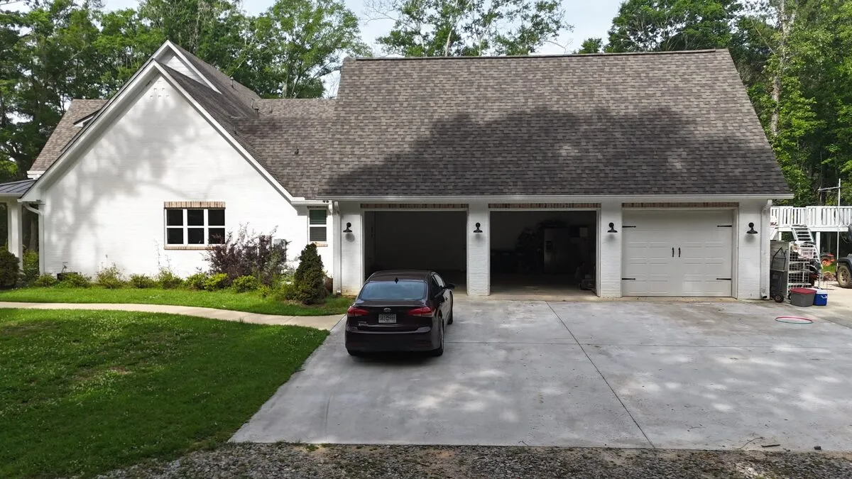 White brick home with a new architectural shingle roof by Dickerson Contracting