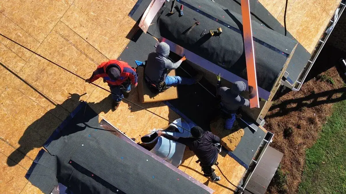 Overhead view of roofers working on an opened roof deck on a Dickerson Contracting job, roof repair serving Vicksburg, MS