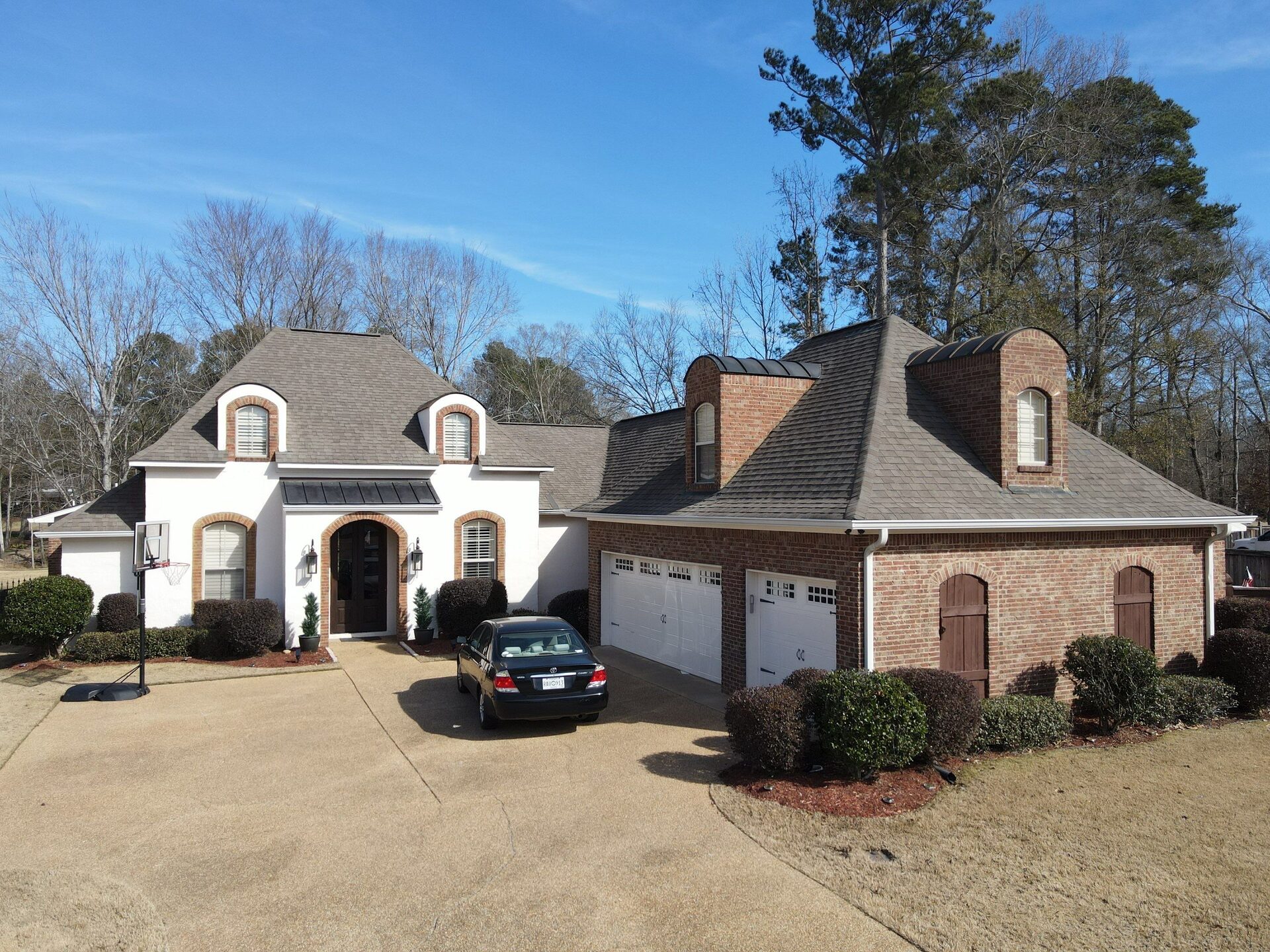 Finished architectural shingle roof with multiple gables on a Central Mississippi home