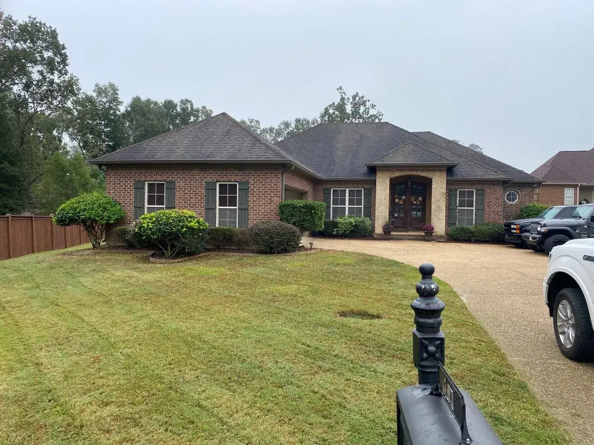Finished residential roof on a white brick home in central Mississippi, roofing company serving Ridgeland, MS