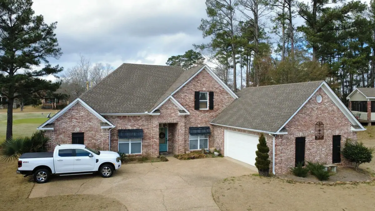 Roofers finishing a residential roof on a Dickerson Contracting roofing job
