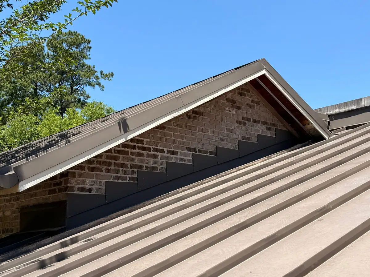 Standing seam metal roof and brick gable on a Dickerson Contracting job in central Mississippi