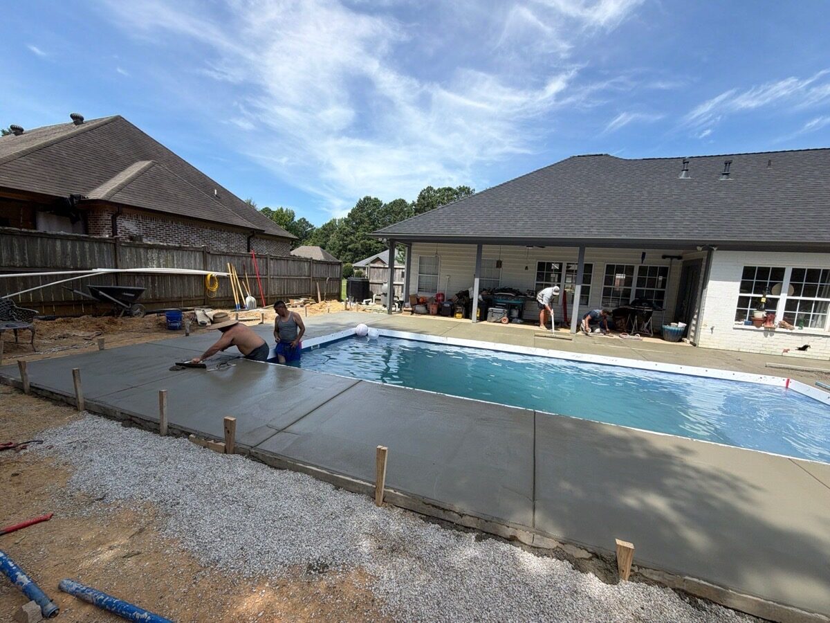 Fiberglass shell set and the deck being poured by the crew