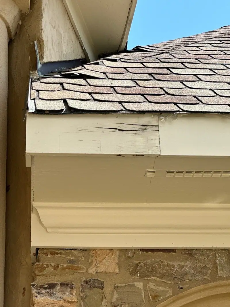 Damaged shingles and fascia at a roof edge, roof repair by Dickerson Contracting serving Flowood, MS