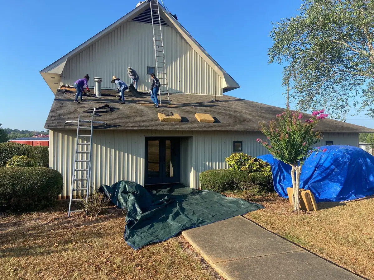 Roofers working on a shingle roof, roof repair and replacement by Dickerson Contracting serving Flowood, MS
