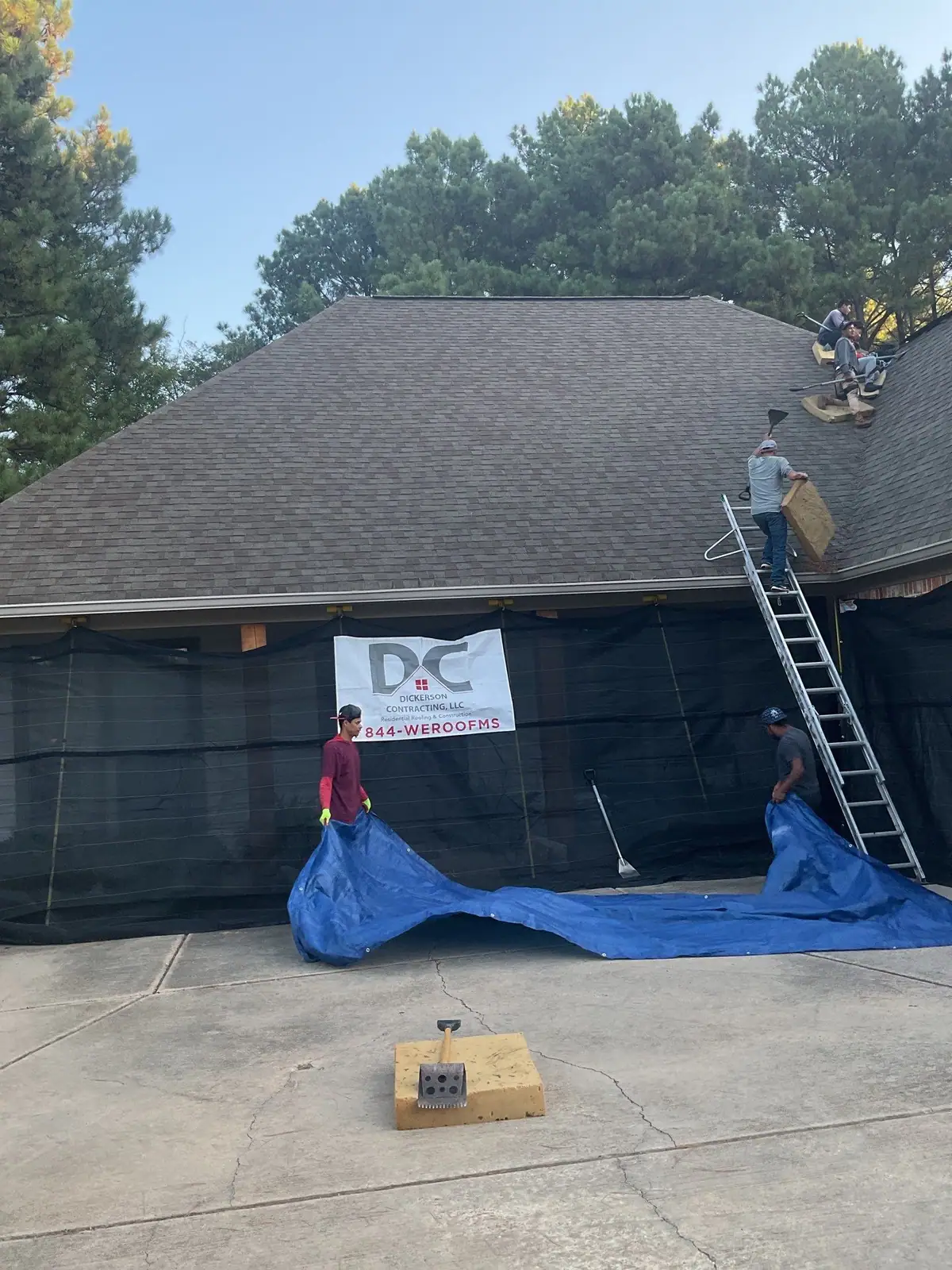 Roofers at work on a shingle roof in Madison, MS, by roofing company Dickerson Contracting