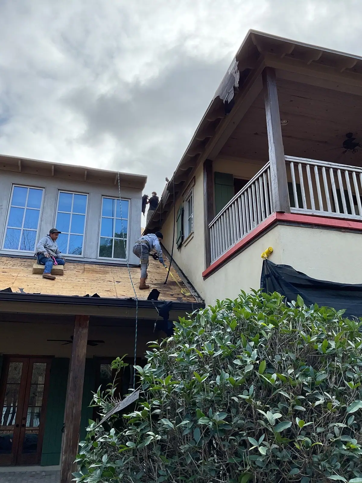 Roofing crew working a shingle roof in Madison, MS, by roofing company Dickerson Contracting