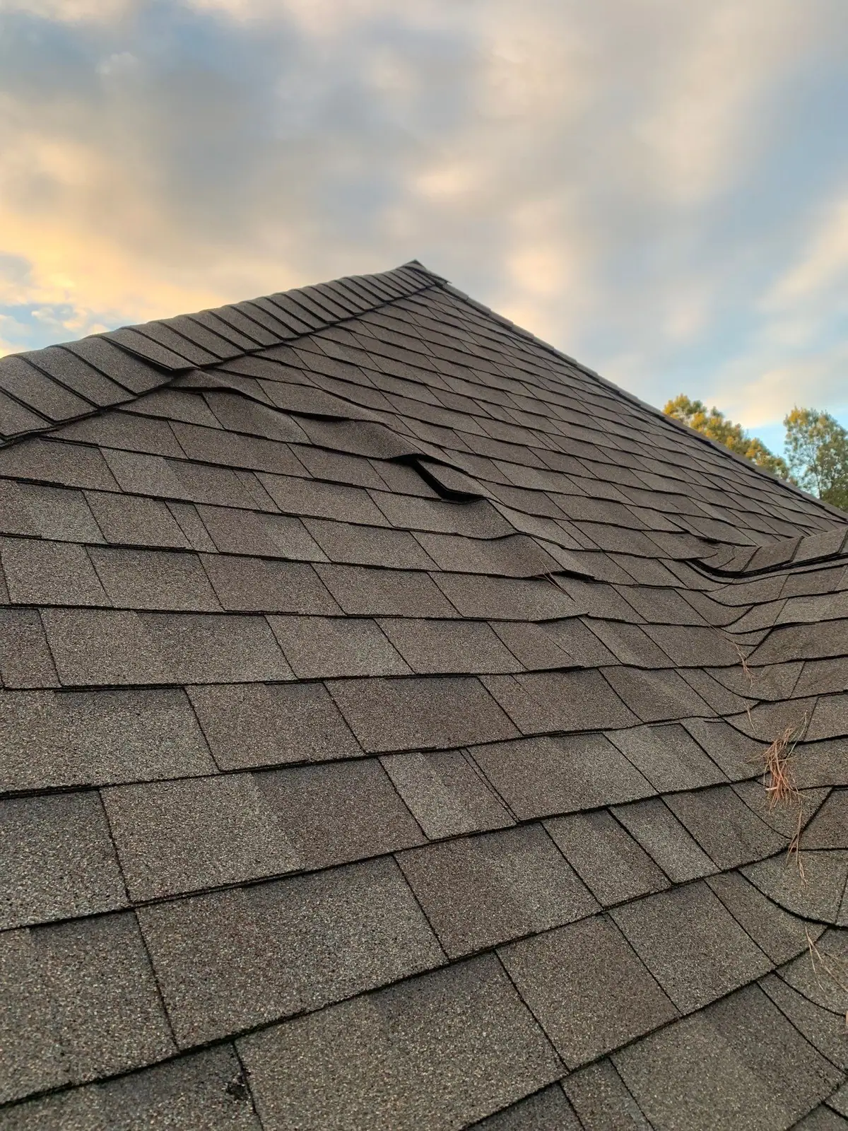 Damaged shingles on a roof before the work, roof repair by Dickerson Contracting in Brandon, MS