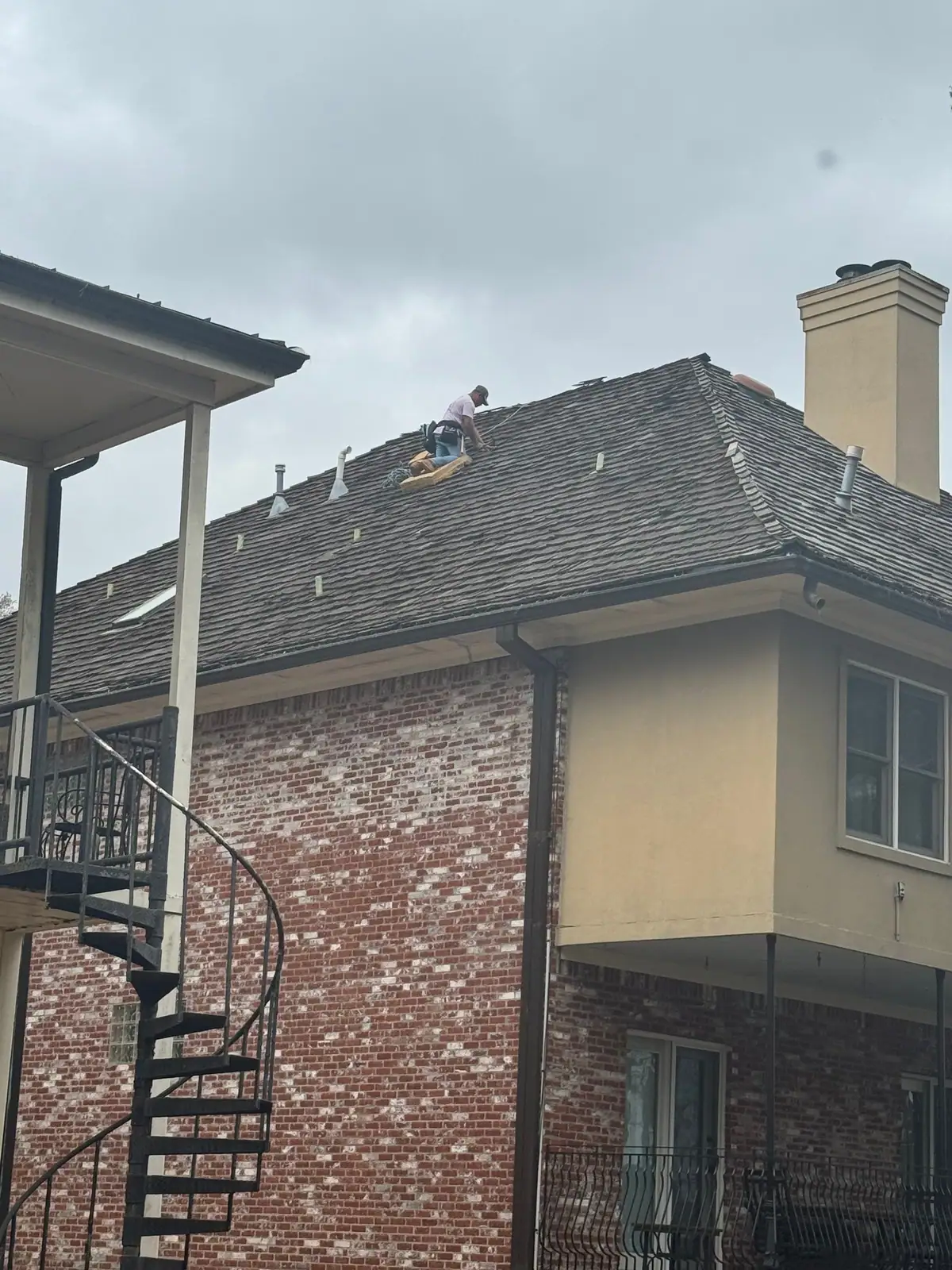 Roofers at work on a shingle roof, residential roofing by Dickerson Contracting in Madison, MS