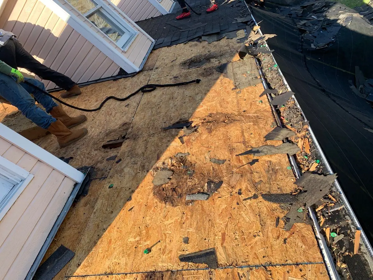Damaged roof decking opened up during a tear-off, roof repair by Dickerson Contracting in Madison, MS