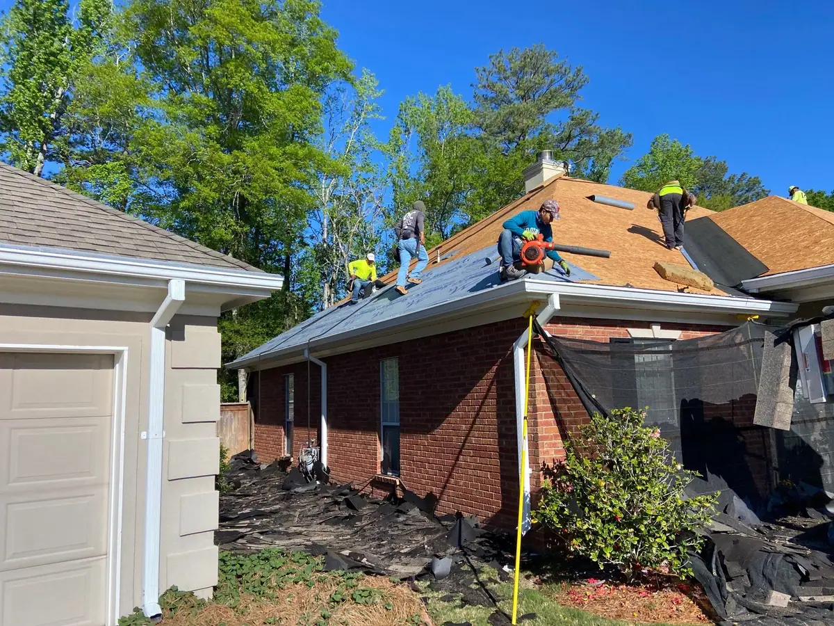 Roofers installing new shingles, roof repair and replacement by Dickerson Contracting in Brandon, MS
