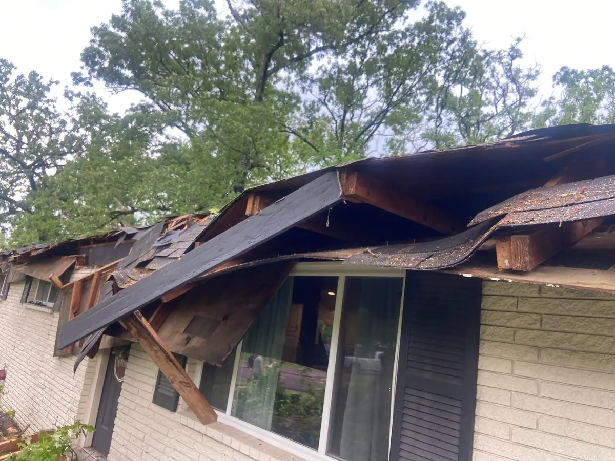 Damaged roof decking opened up during a tear-off in Pearl, MS, by roofing company Dickerson Contracting