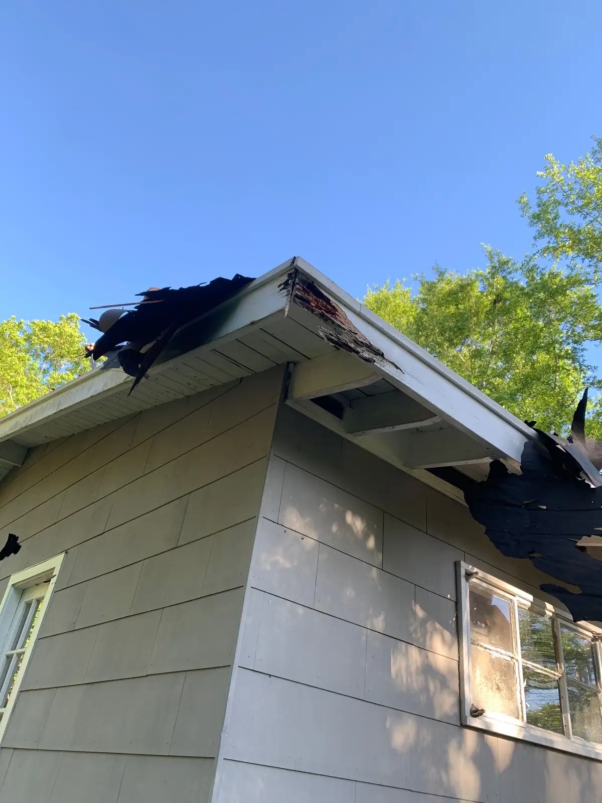 Damaged shingles on a roof before the work, roof repair by Dickerson Contracting in Clinton, MS