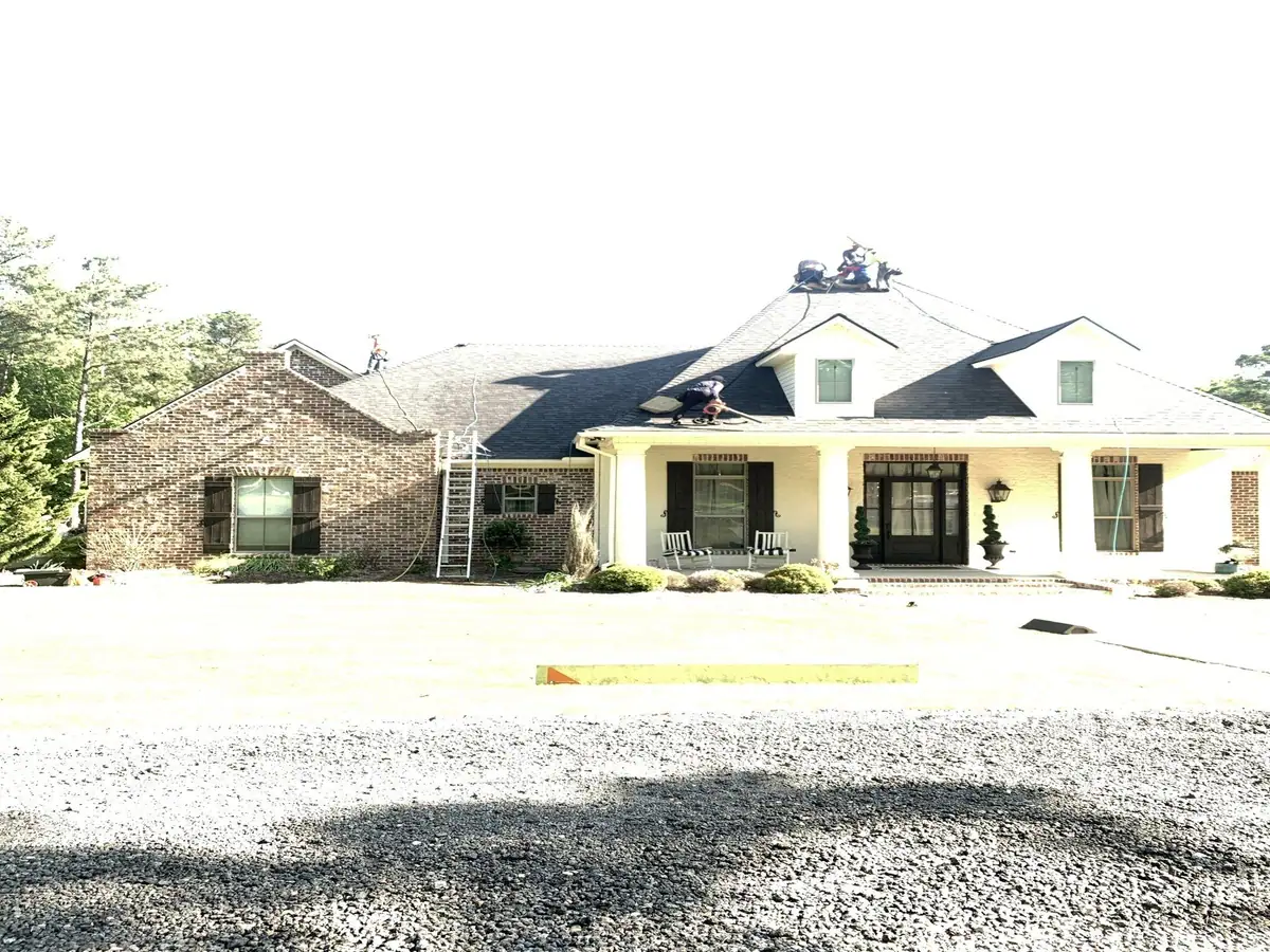 Roofers working on a shingle roof, roof repair and replacement by Dickerson Contracting serving Vicksburg, MS