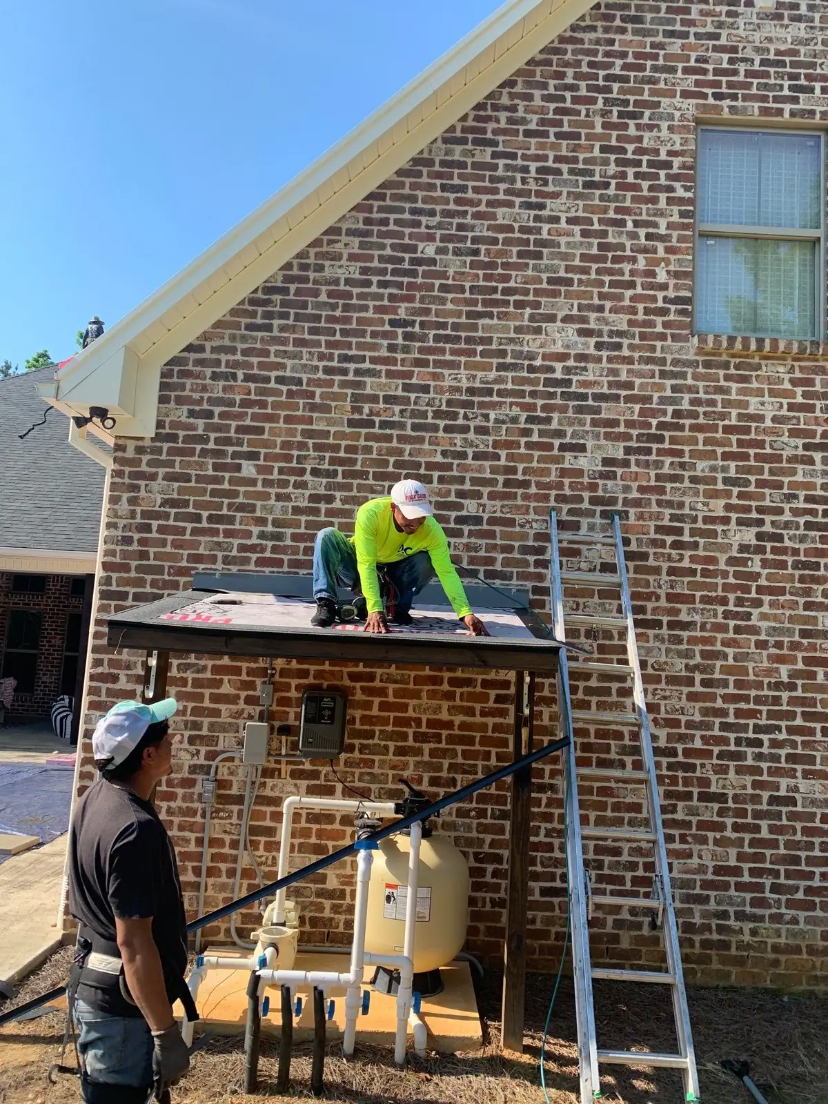 Roofers laying a new membrane on a flat commercial roof, commercial roofing by Dickerson Contracting in Brandon, MS