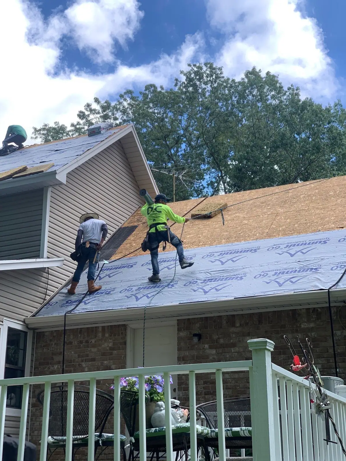 Roofers installing new shingles, residential roofing by Dickerson Contracting in Clinton, MS