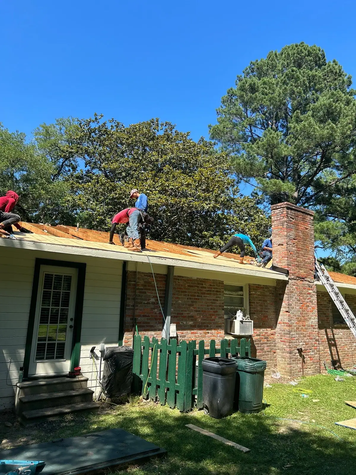 Roofers replacing a shingle roof, roof repair and replacement by Dickerson Contracting in Clinton, MS
