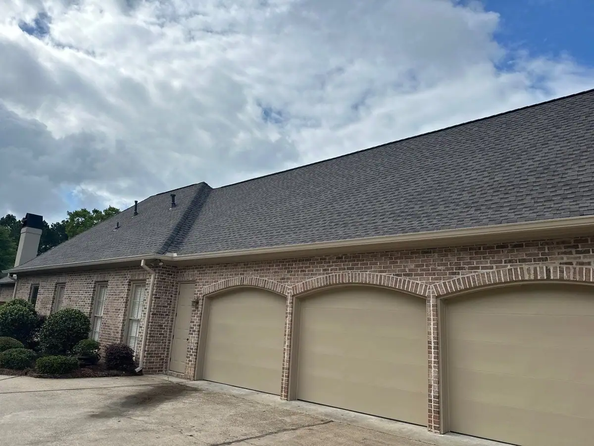 Long ridge line of a new shingle roof over a brick home, residential roofing by Dickerson Contracting
