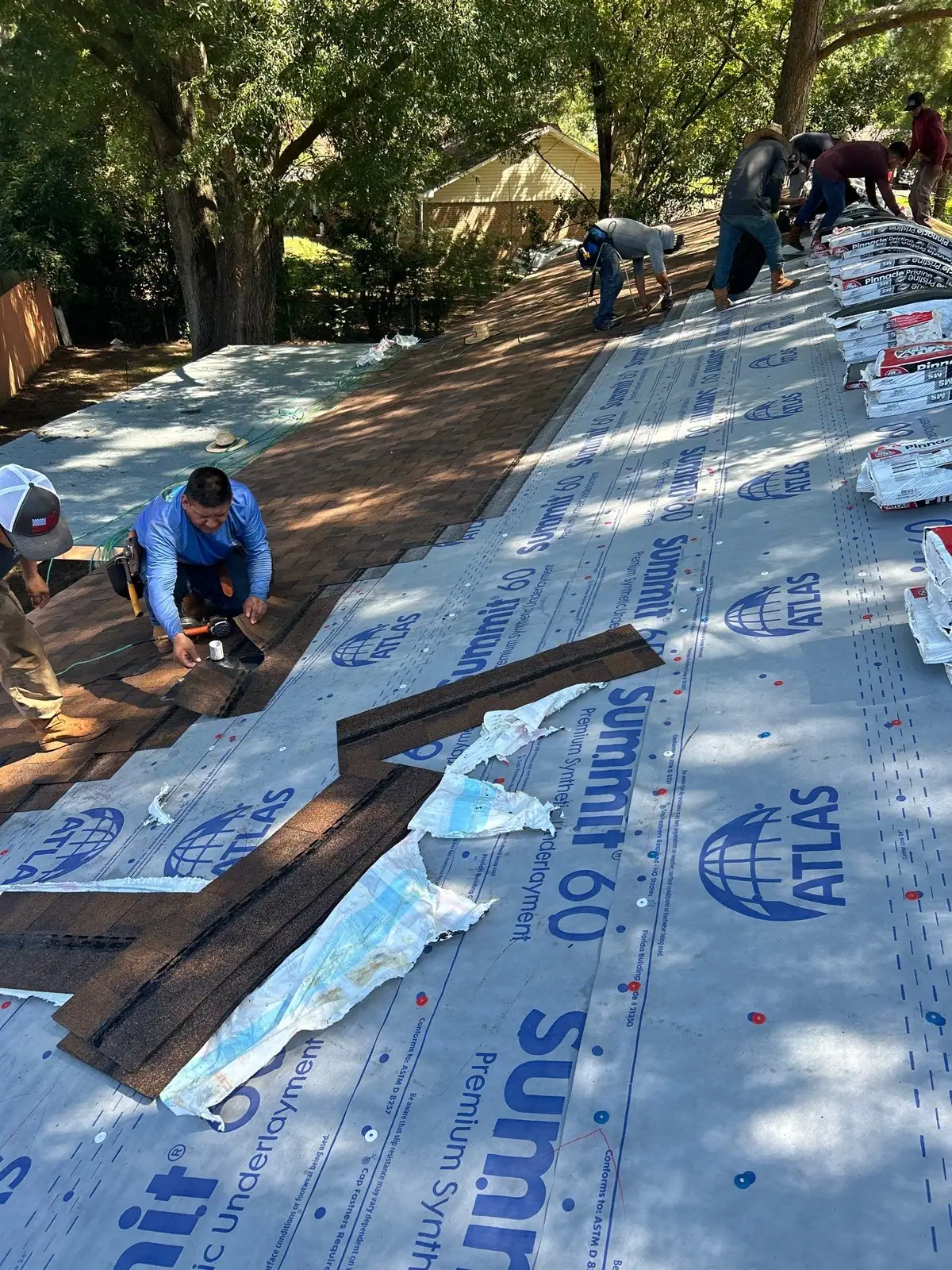 Roofers installing new shingles in Pearl, MS, by roofing company Dickerson Contracting