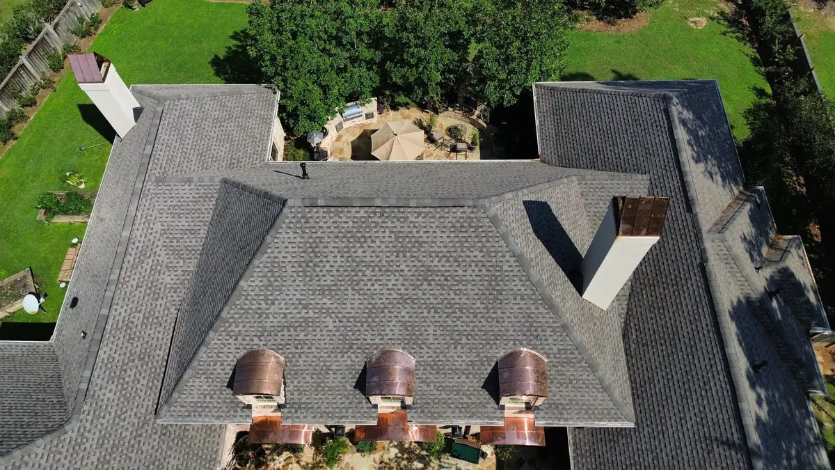 Copper eyebrow dormers set into a new shingle roof, from above, a Dickerson Contracting roofing job