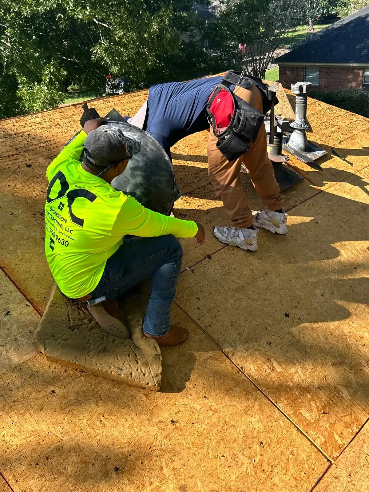 Roofers mid-way through a shingle roof replacement in Ridgeland, MS, by roofing company Dickerson Contracting