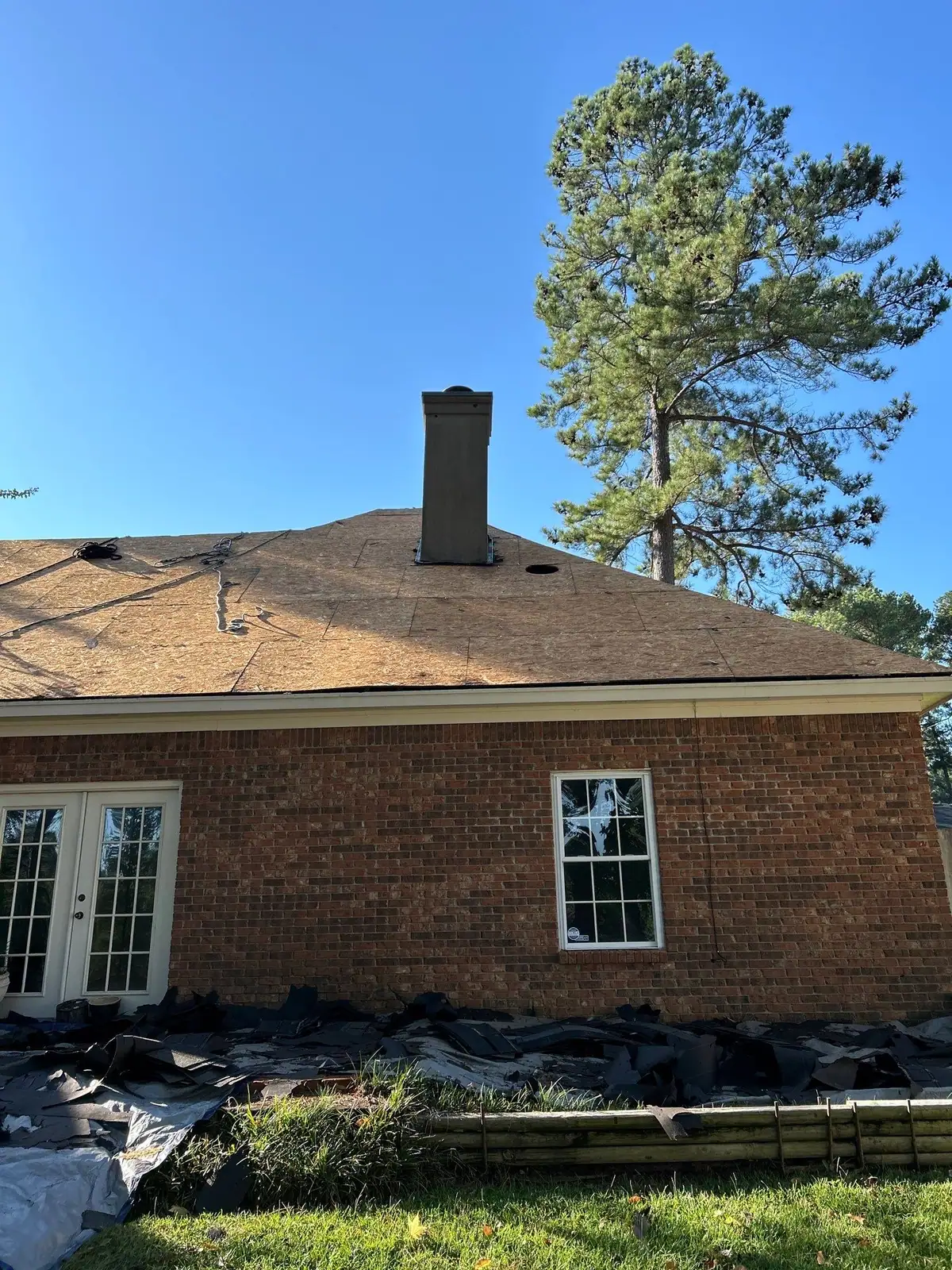 Damaged roof decking opened up during a tear-off, roof repair by Dickerson Contracting in Ridgeland, MS