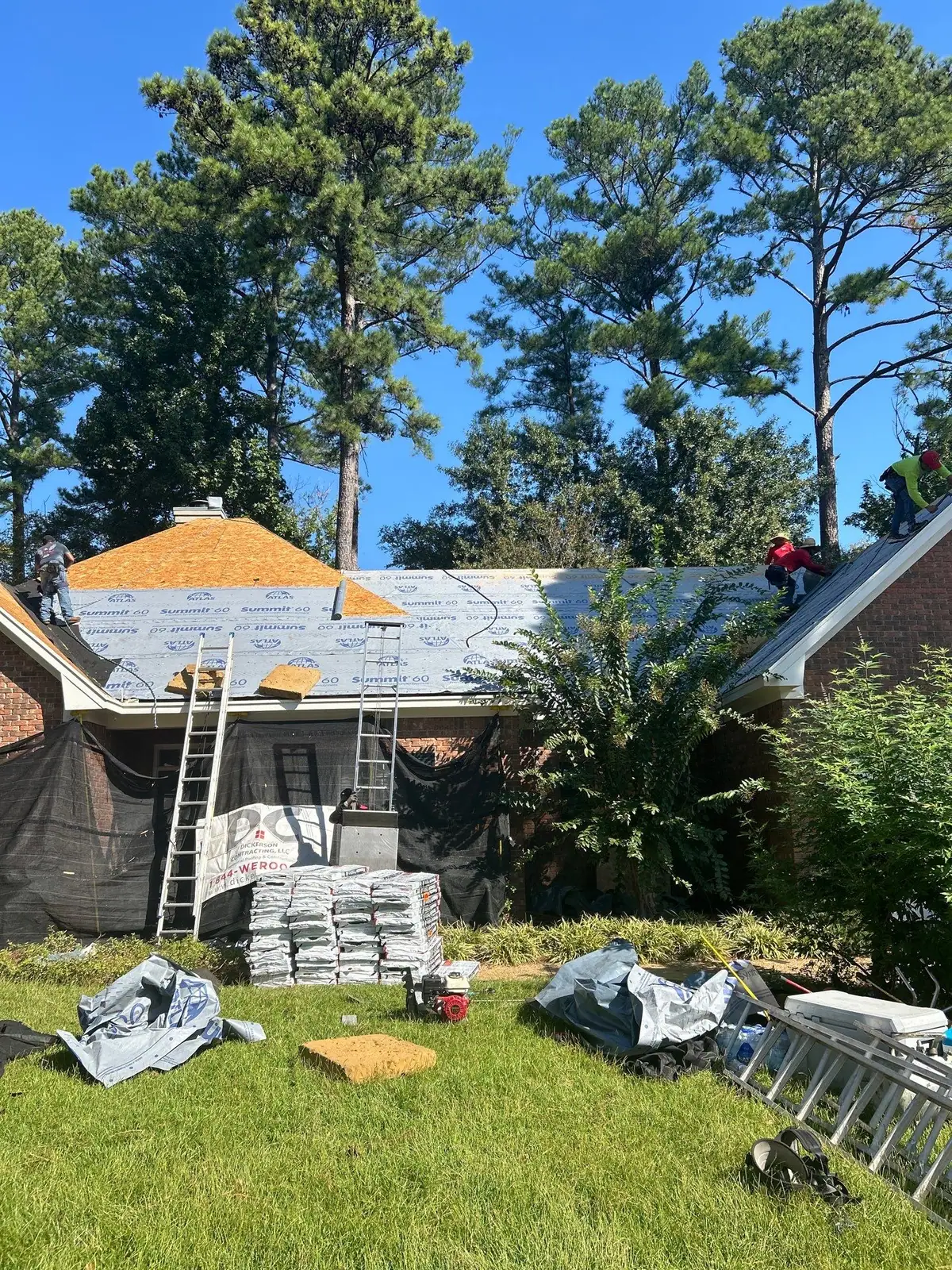 Roofers installing new shingles in Ridgeland, MS, by roofing company Dickerson Contracting