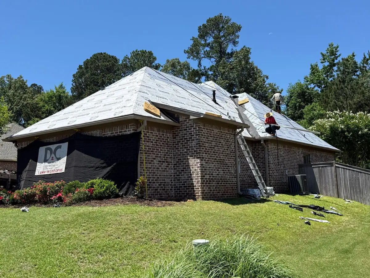Roofers re-roofing a two-story brick home for Dickerson Contracting, a central Mississippi roofing company