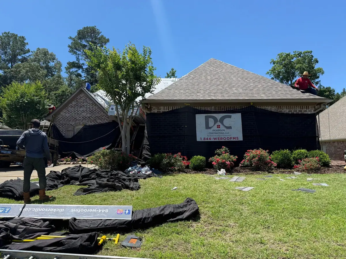 Dickerson sign in the yard while the crew re-roofs the house