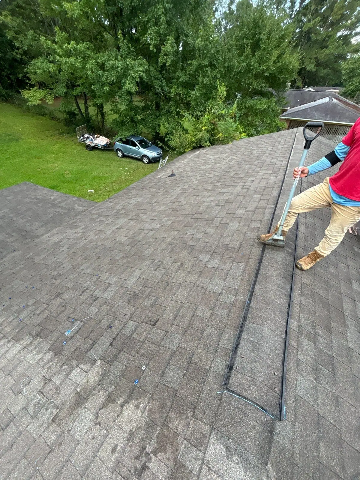 Roofers at work on a shingle roof in Pearl, MS, by roofing company Dickerson Contracting