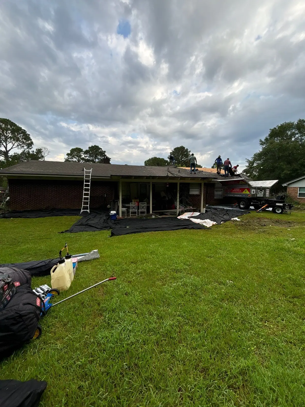 Roofers at work on a shingle roof, residential roofing by Dickerson Contracting in Pearl, MS