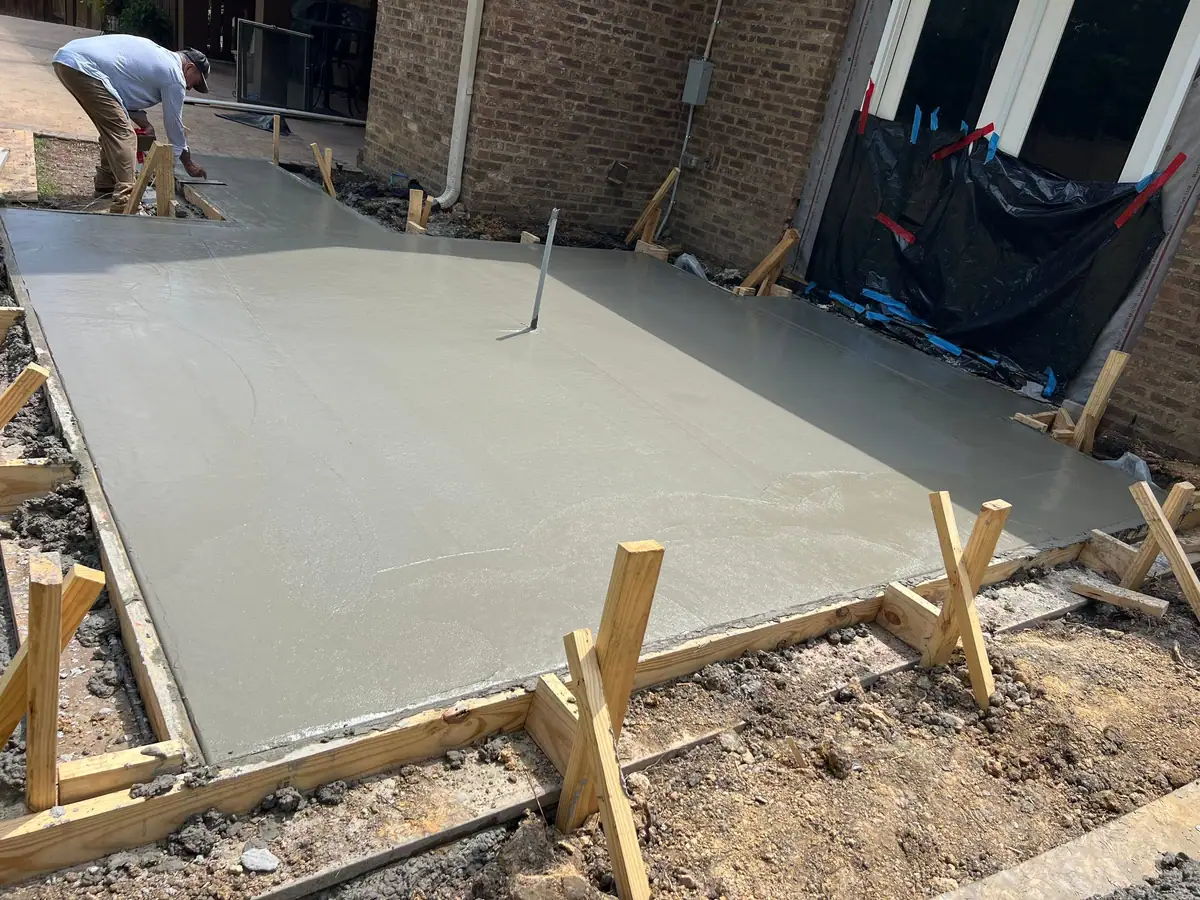 Freshly poured concrete patio slab in its forms for an outdoor living space