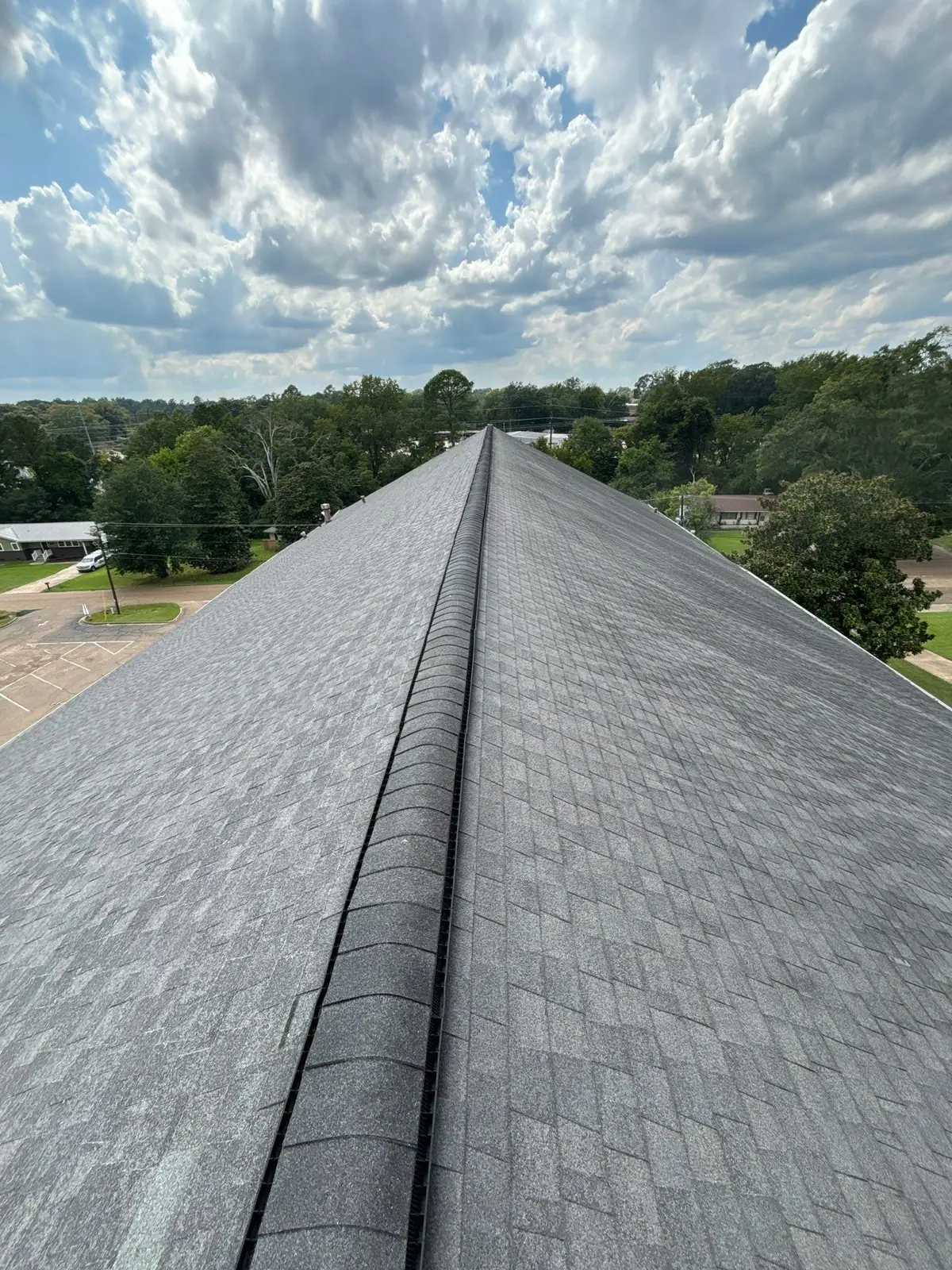 Aerial view of a finished shingle roof in Clinton, MS, by roofing company Dickerson Contracting
