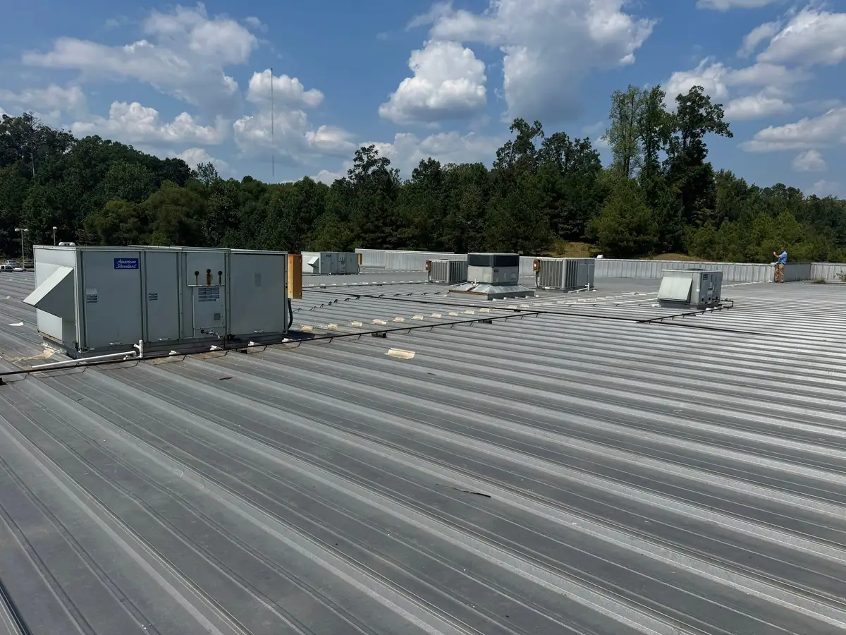 Metal panels around rooftop units on a commercial roof by Dickerson Contracting