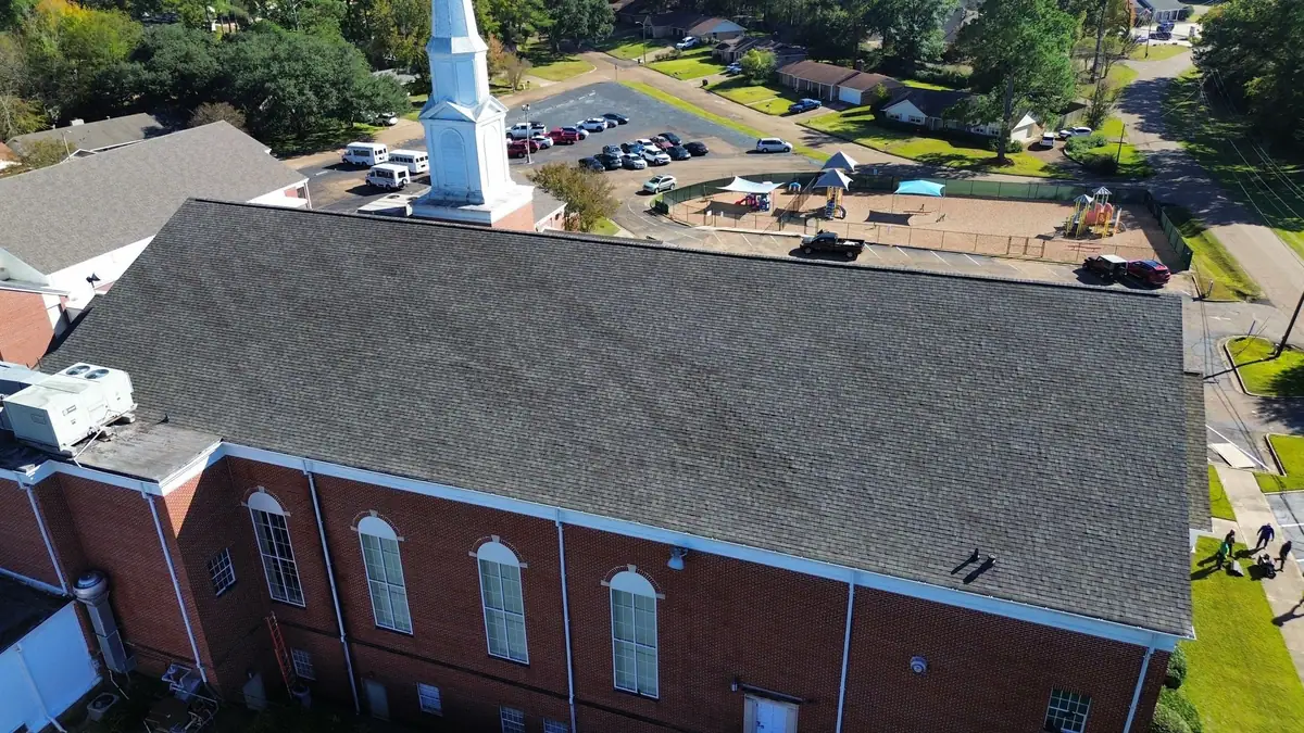 Church re-roof with the steeple and parking lot beyond, commercial roofing by Dickerson Contracting
