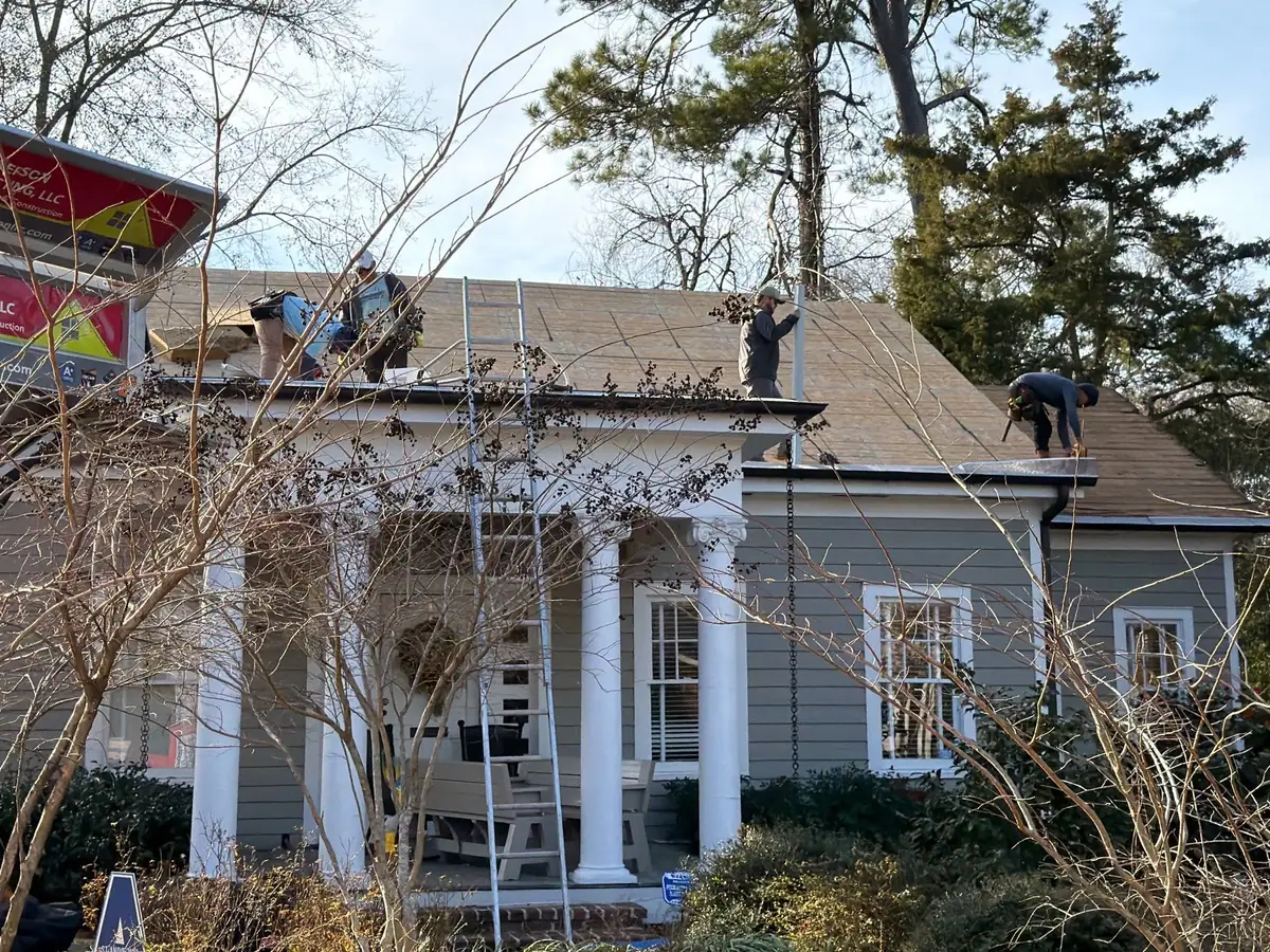 Roofers working on a shingle roof, roof repair and replacement by Dickerson Contracting in Jackson, MS