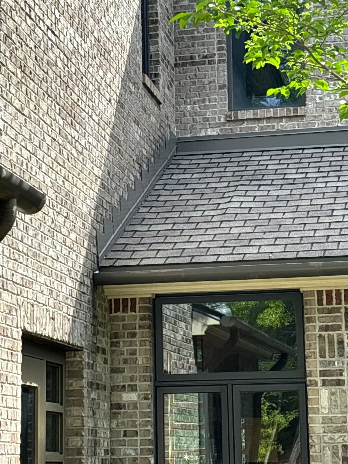 New shingles meeting the window trim on a finished roof, residential roofing by Dickerson Contracting in Ridgeland, MS