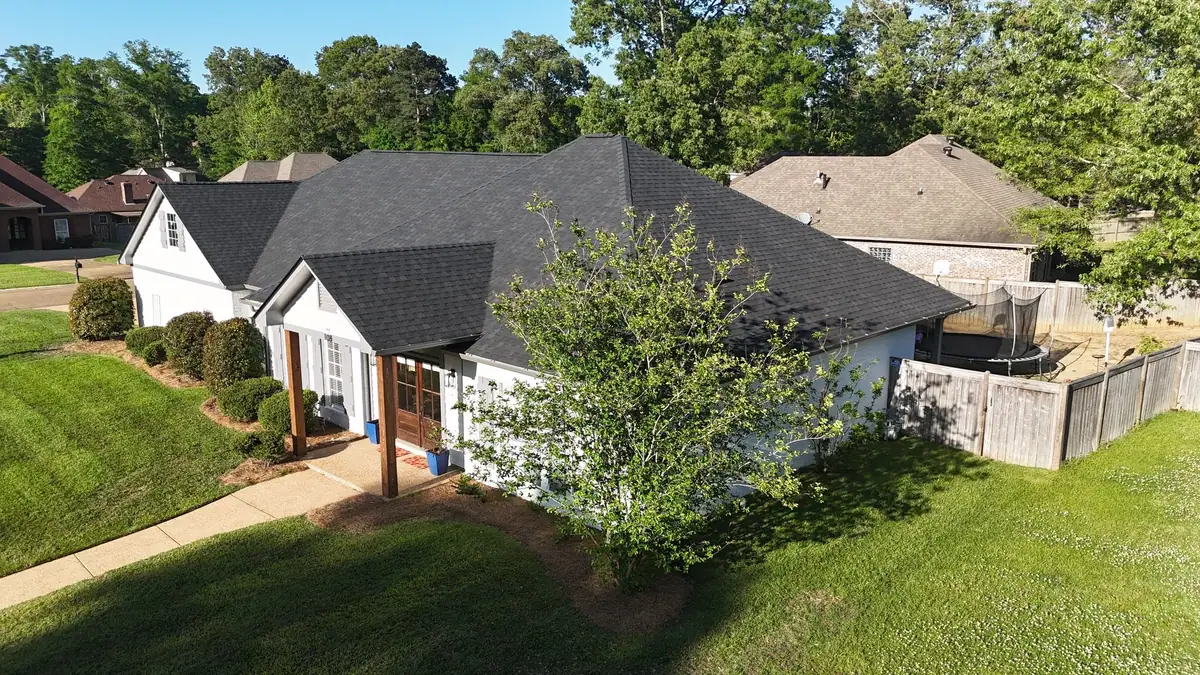 Finished shingle roof on a white home with a covered entry, residential roofing by Dickerson Contracting