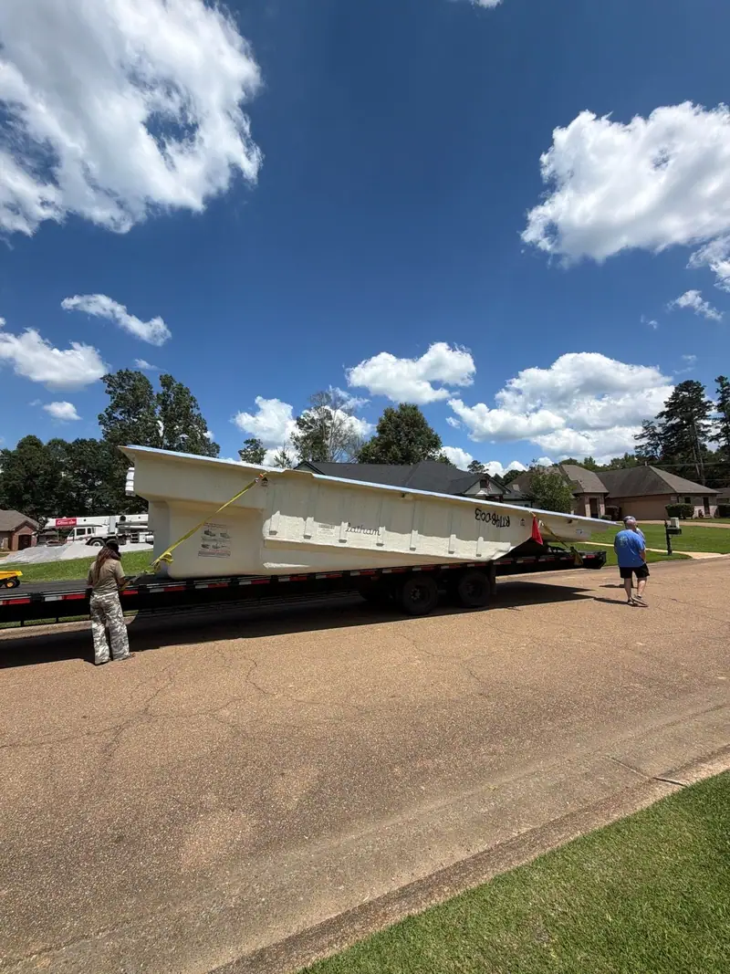 Fiberglass pool shell on its delivery trailer