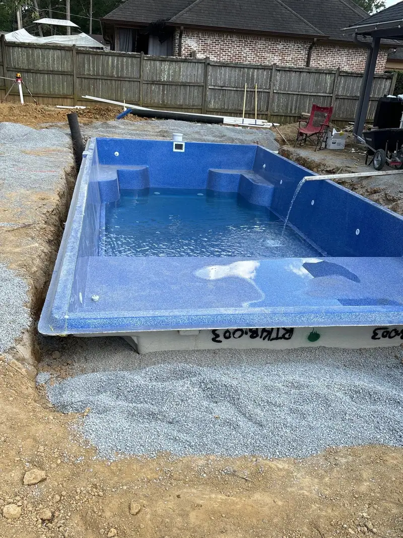 Fiberglass pool shell set level on a gravel base