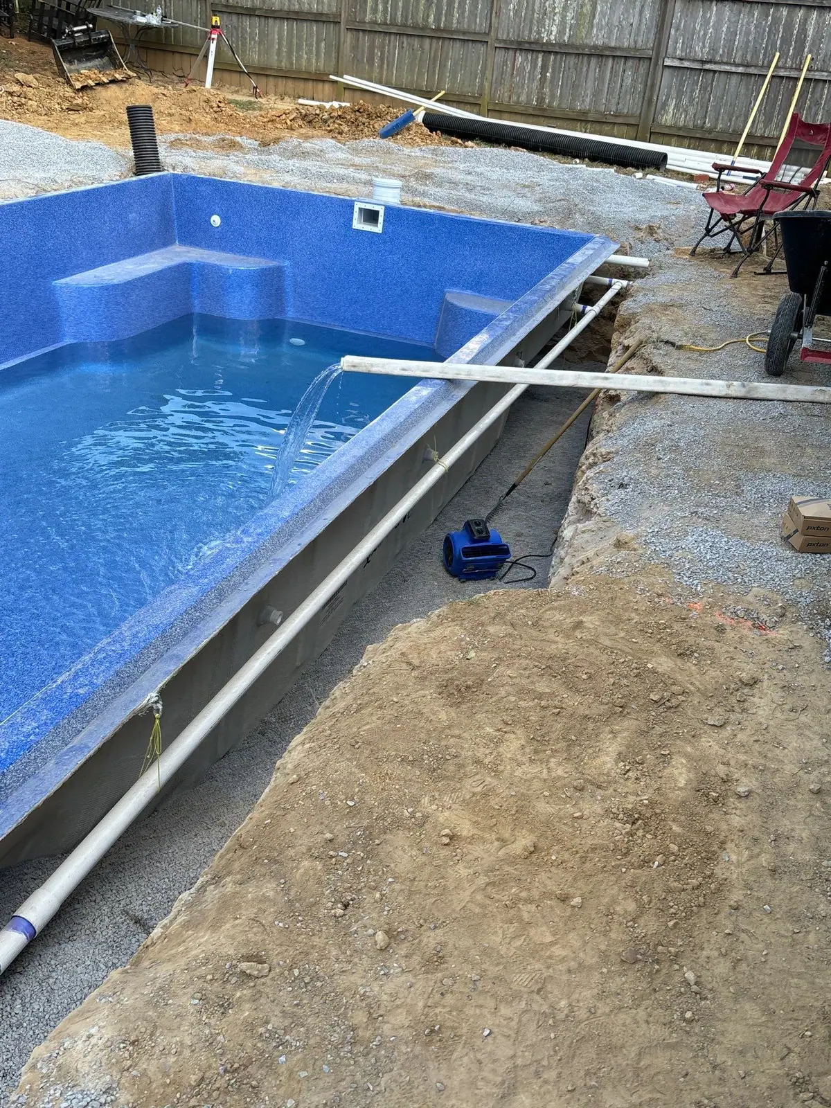 Inground pool shell filling with water during backfill by DC Pools and Spas serving Jackson, MS