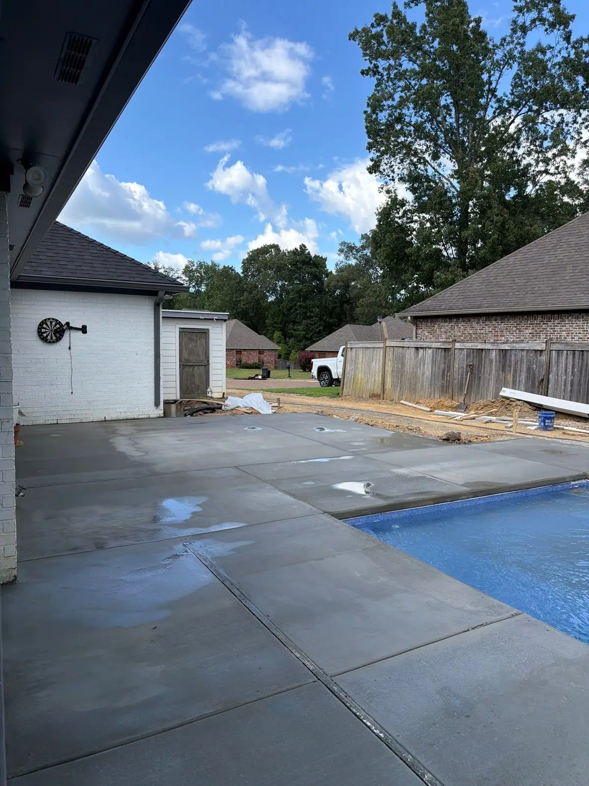 Finished fiberglass pool with its concrete deck and patio by DC Pools and Spas, pool company serving Vicksburg, MS