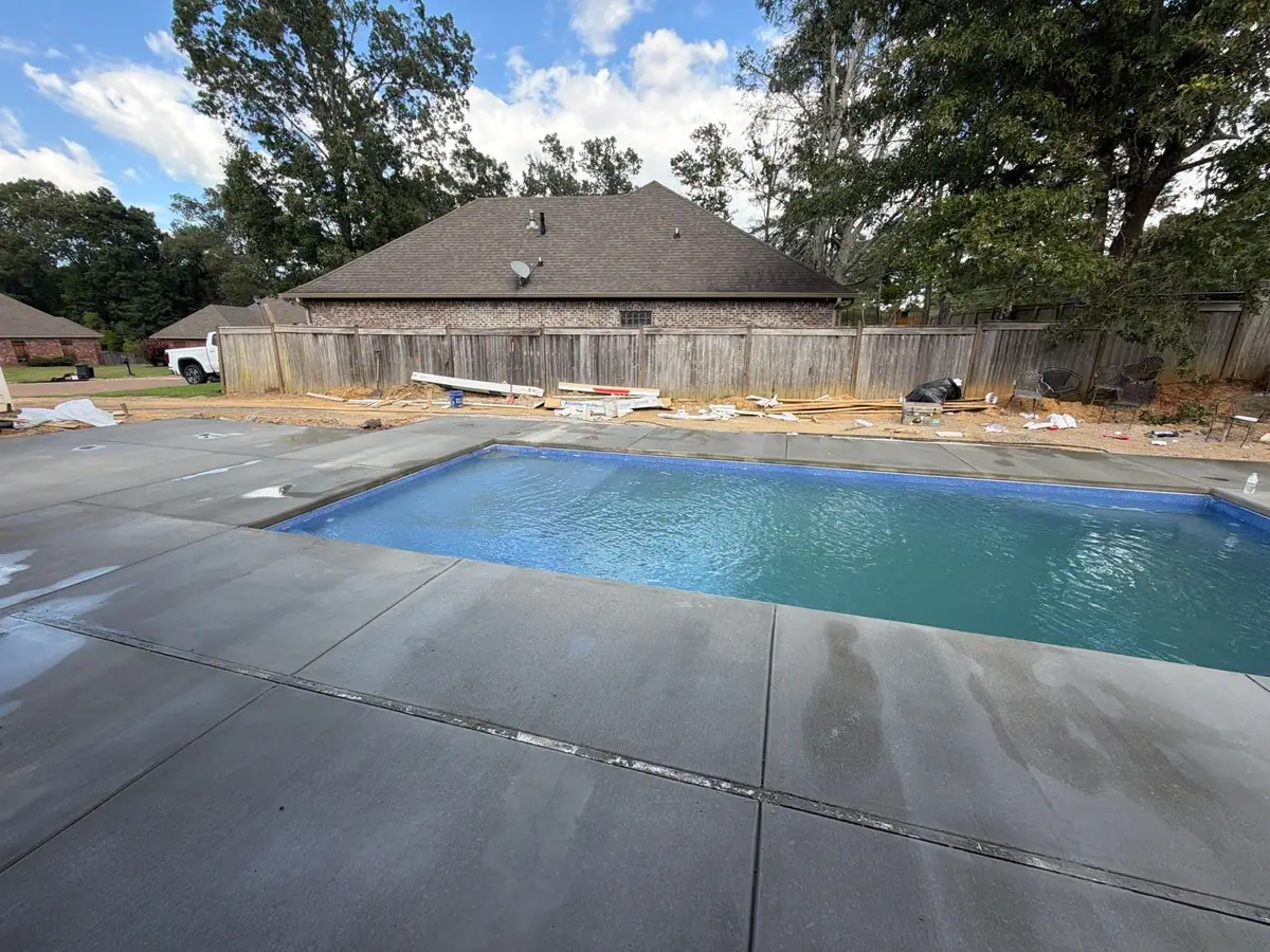 Completed fiberglass pool with its concrete deck by DC Pools and Spas, pool company serving Ridgeland, MS