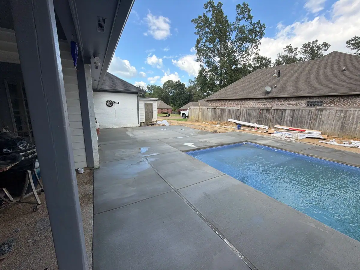 Completed fiberglass pool with its concrete deck by DC Pools and Spas, pool company serving Pearl, MS