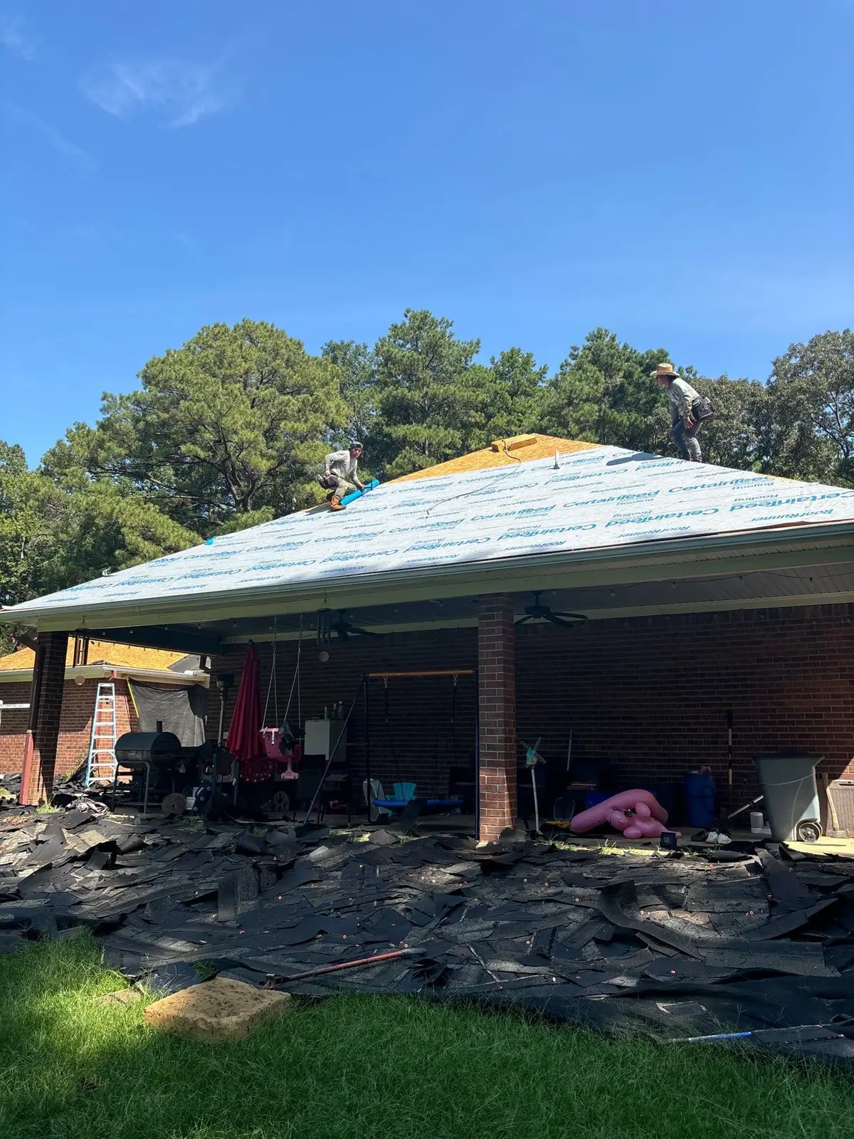 Roofers installing new shingles, roof repair and replacement by Dickerson Contracting in Pearl, MS