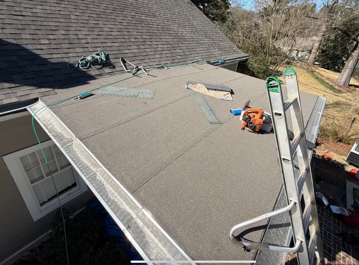Roofers working on a shingle roof in Flowood, MS, by roofing company Dickerson Contracting