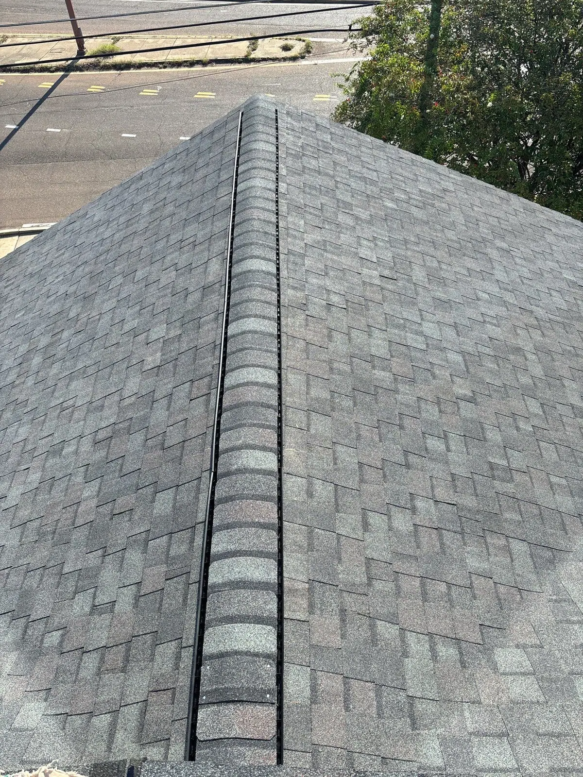New hip shingles and ridge cap on a finished roof, roof repair and replacement by Dickerson Contracting in Jackson, MS