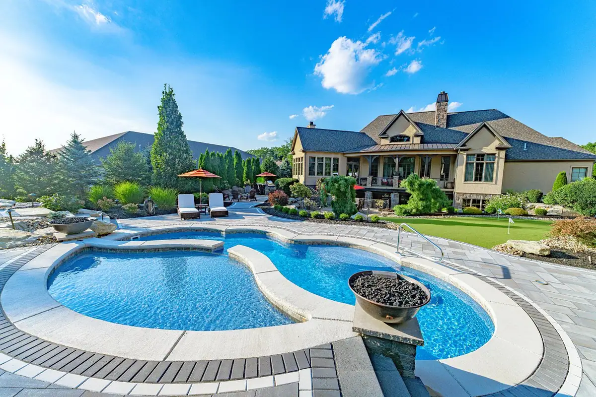 Fiberglass pool with a tanning ledge and fire pit (Latham photo), a model DC Pools and Spas installs serving Brandon, MS