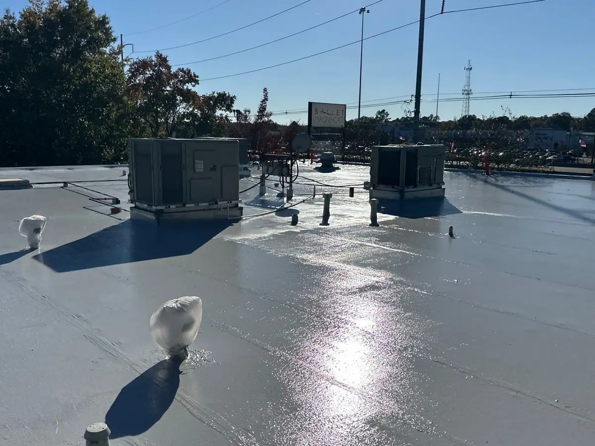 Freshly coated commercial flat roof with rooftop HVAC units, commercial roofing by Dickerson Contracting serving Clinton, MS